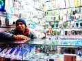 Man standing by his phone stall 2