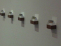  Four triangles made of glass with small scenary images embeded within them    