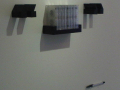  Cassetes on a shelf with blaxk musical notes made of dark wood    