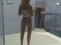  A woman holding her skirt up and you can see her internal organs reflection in the mirror    