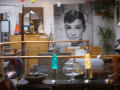 A shop full of modern and old items including a Audrey Hepburn poster