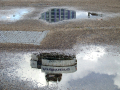 Building reflected in a puddle 