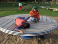 Children playing on a roundabout 