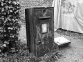 Black and white photo of old post box