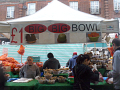 People selling fruit under awning