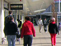 people walking along the pavement