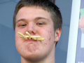 Boy with chips in his mouth