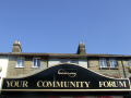 Community Forum sign in front of housing