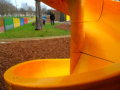 Yellow curly slide in play area