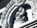 Carving of a lady praying in the stone wall