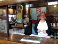Lady serving behind the bar