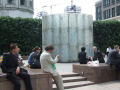people relaxing around an artwork