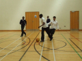 young boys playing football at indoor sports hall