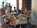 3 men eating inside