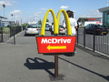 yellow and red sign for the drive through