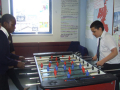 boys playing table soccer
