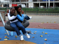 girls playing on tyre swings