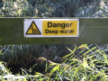 danger deep water sign on fence