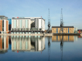 The Hotel Ibis and other buildings reflected in the river.