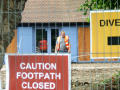 Construction workers with signs in foreground