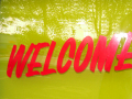 Welcome sign with reflection