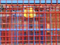 Basketball hoop behind a metal fence