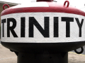 Mooring post on the street with Trinity Buoy name
