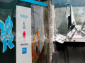 olympic sign next to a pealing bill board