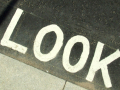 The word LOOK diagonally against a black tarmac background