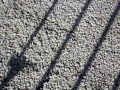 Shadows of gate on stones