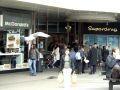 Outside McDonalds, people passing, bird flying