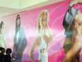 Girls walking in front of large pictures of girls 