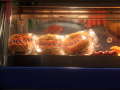 food being kept warm on display - you can see pies and sausages	
